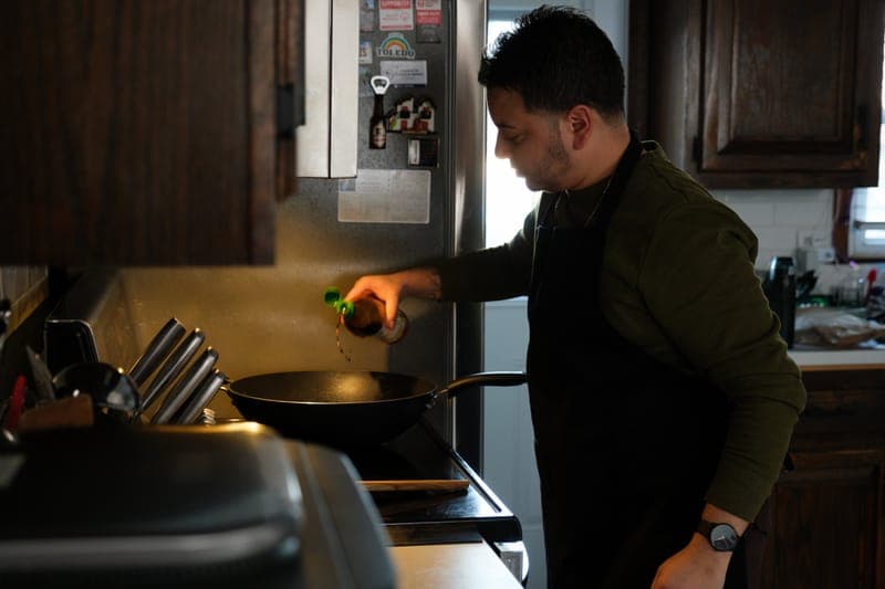 Owner cooking in kitchen